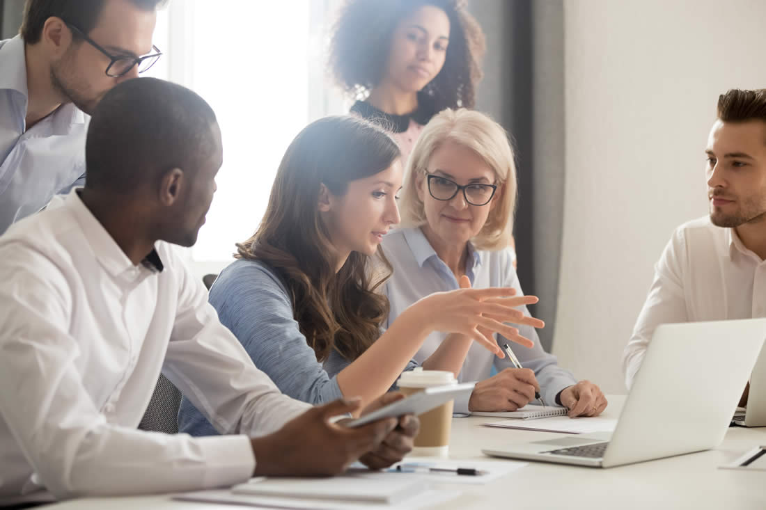 Group of colleagues collaborating at work