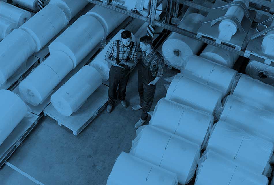 Two warehouse workers looking over a chart